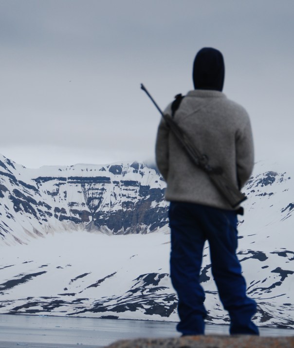 The Expedition Team "scout" each proposed landing site in advance of our boarding the zodiacs. IF the "all clear" signal is given, then expedition staff members - aka "bear guards" are posted at strategic locations around the site where we will hiking and exploring - to ensure our safety, as well as the bear's.(Photo by Robyn Bushong.)